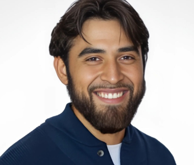 Headshot of a smiling man wearing a navy-blue button up.